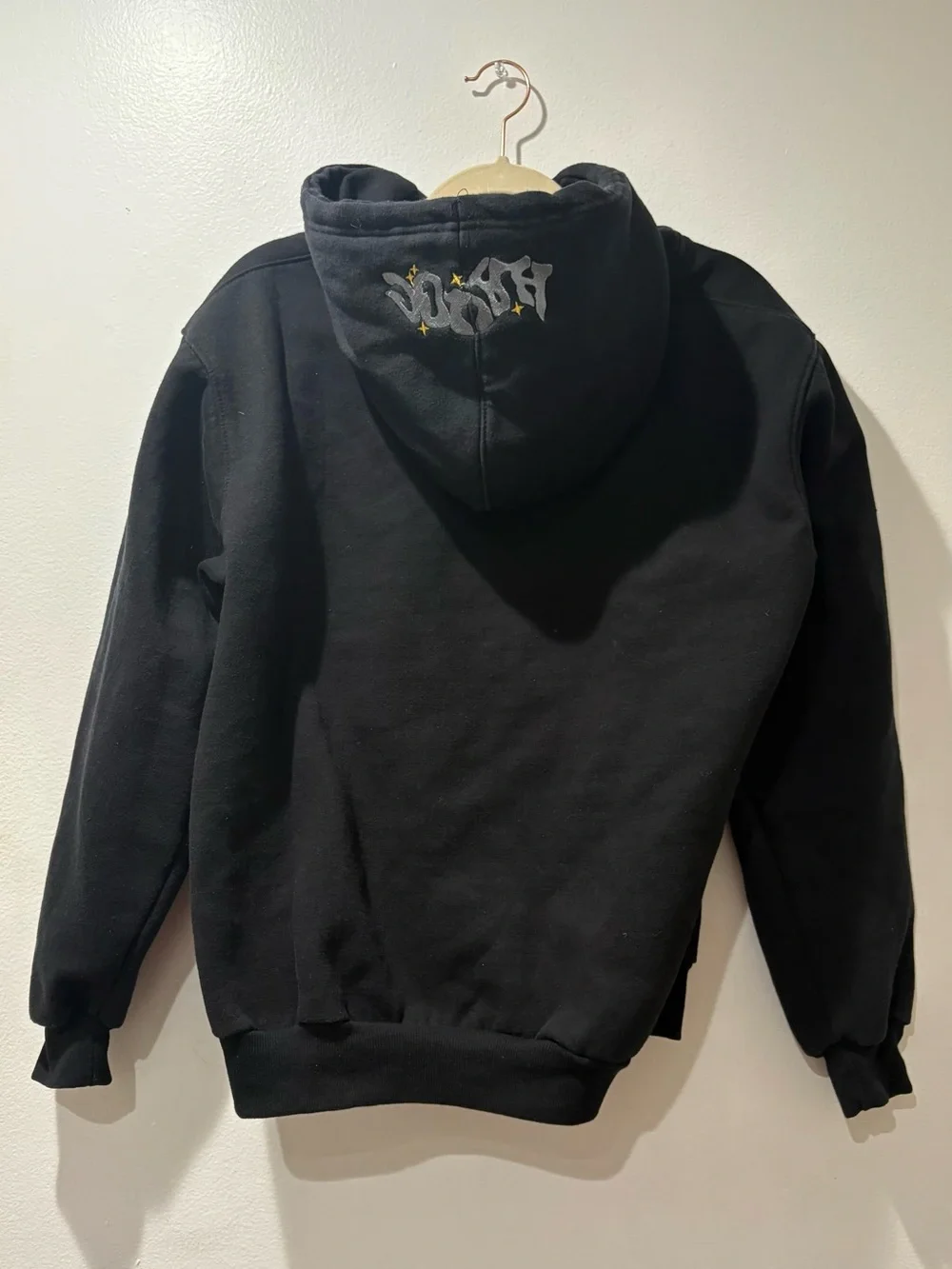 Black Zip-Up Hoodie with Silver Graphic and Yellow Star Accents
